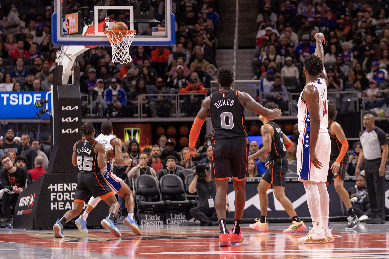 Joel Embiid soaring through the air for a thunderous dunk