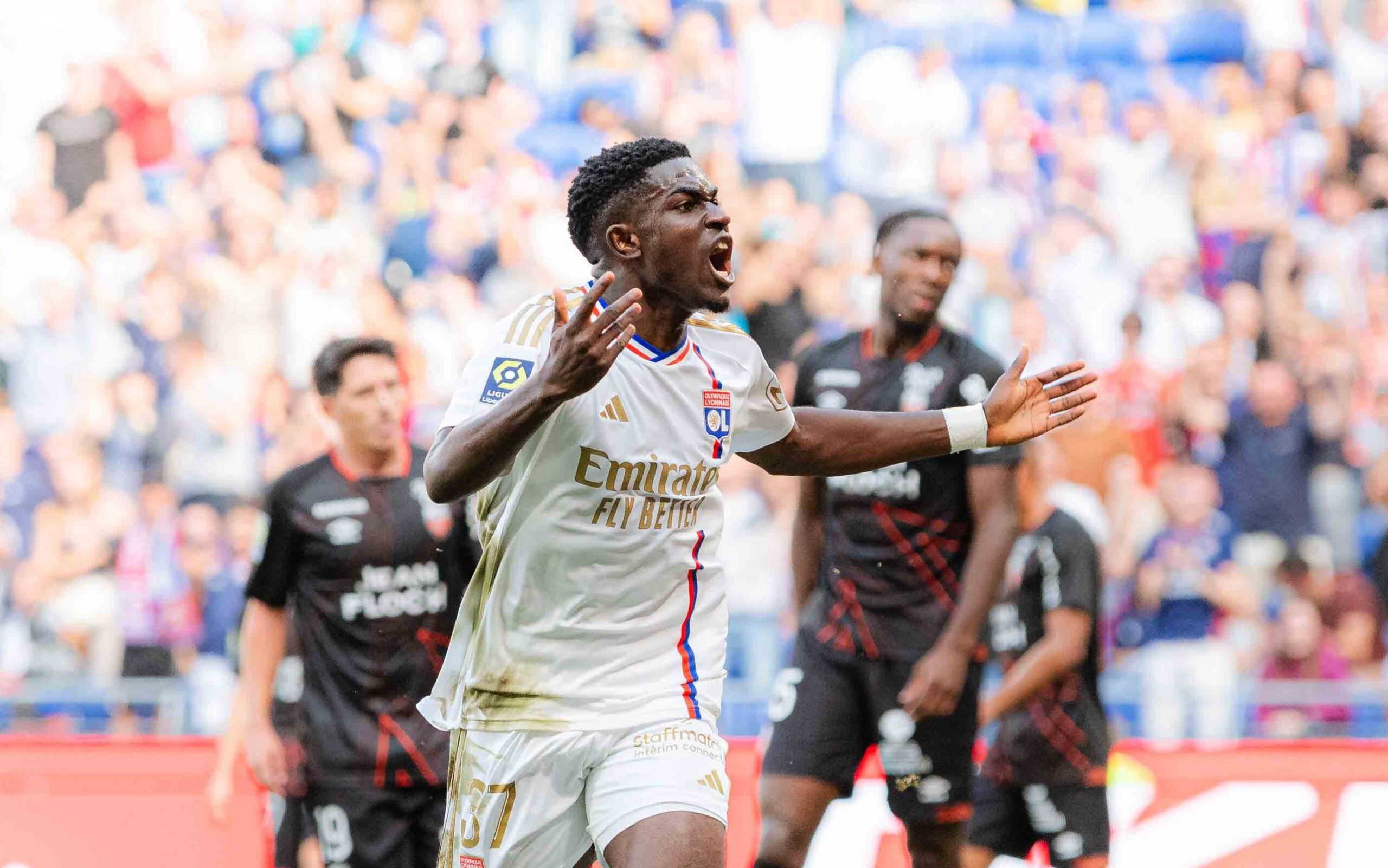 Lyon and Reims players in action during the match